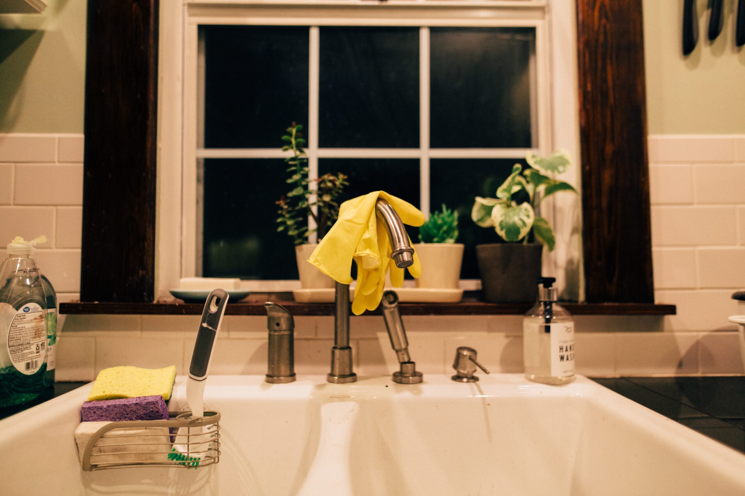 Kitchen sink with rubber gloves over the faucet