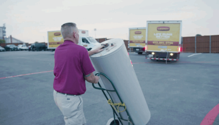 Plumber from Legacy Plumbing delivering a water heater to be installed
