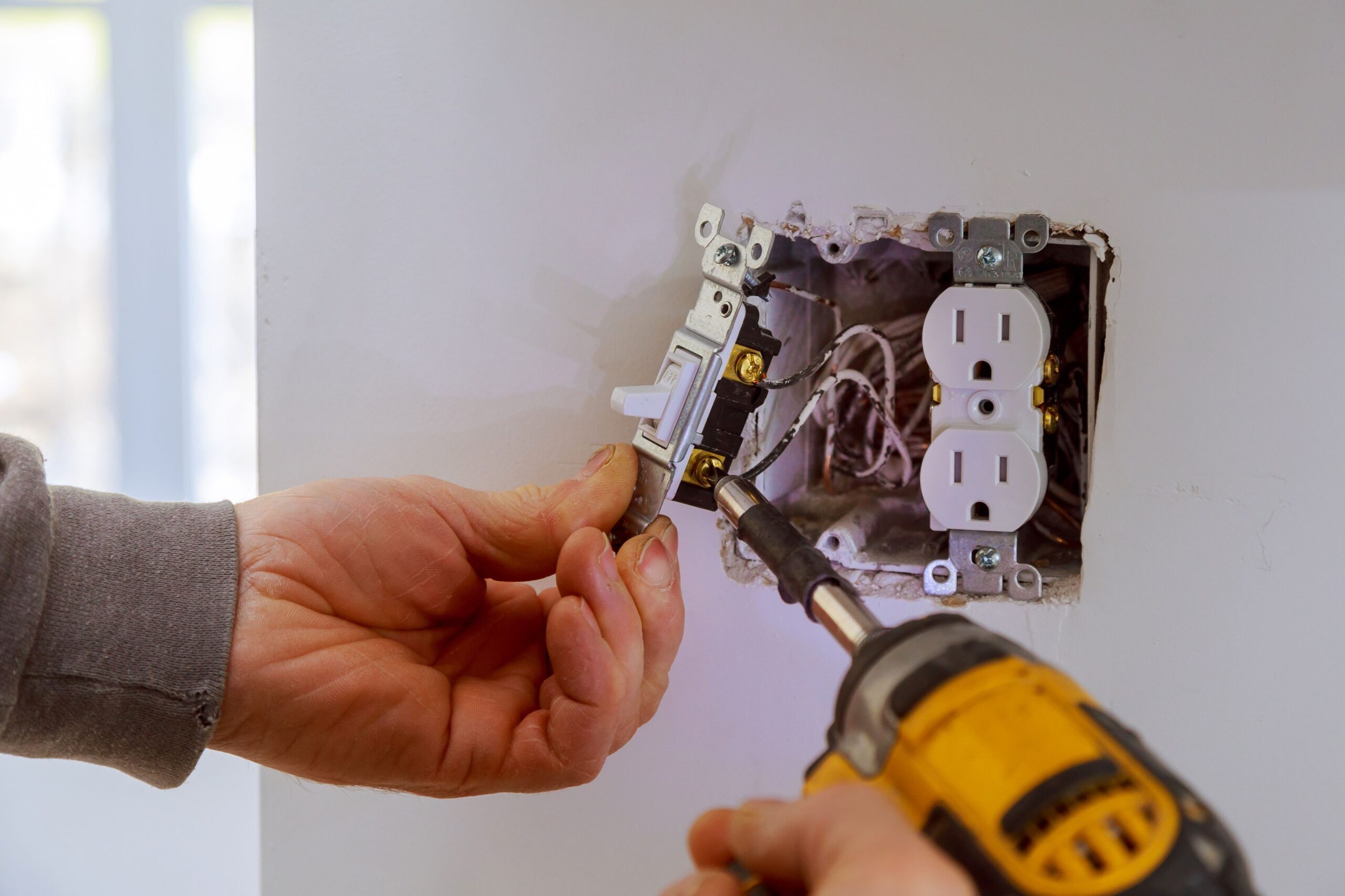 Electrician installing a light switch
