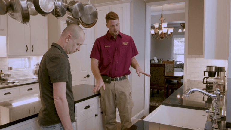 Legacy Plumbing plumber speaking with a homeowner