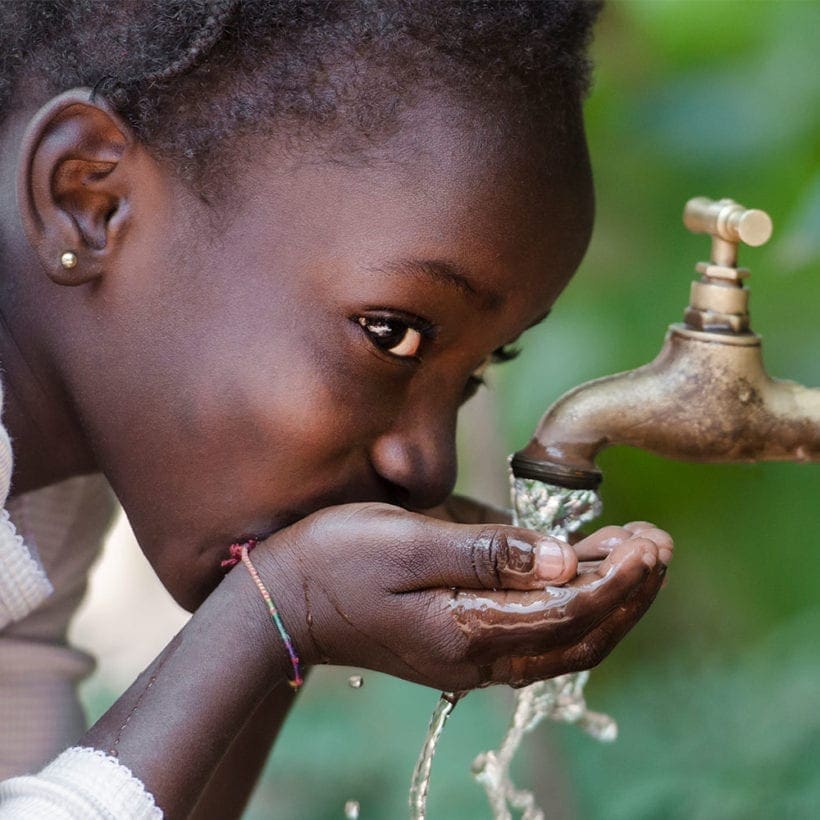 Boy Drinking water from tap