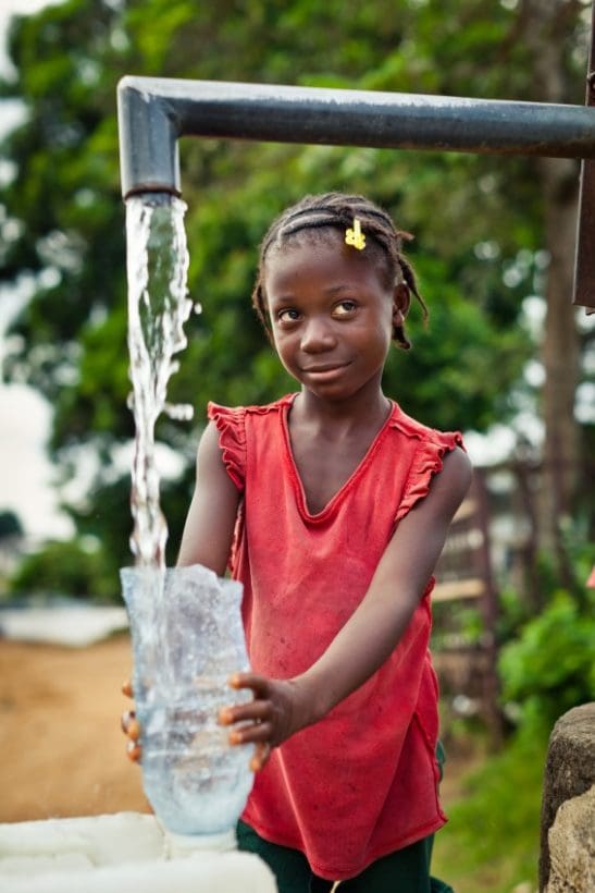 Water filling glass African Girl Water Pump